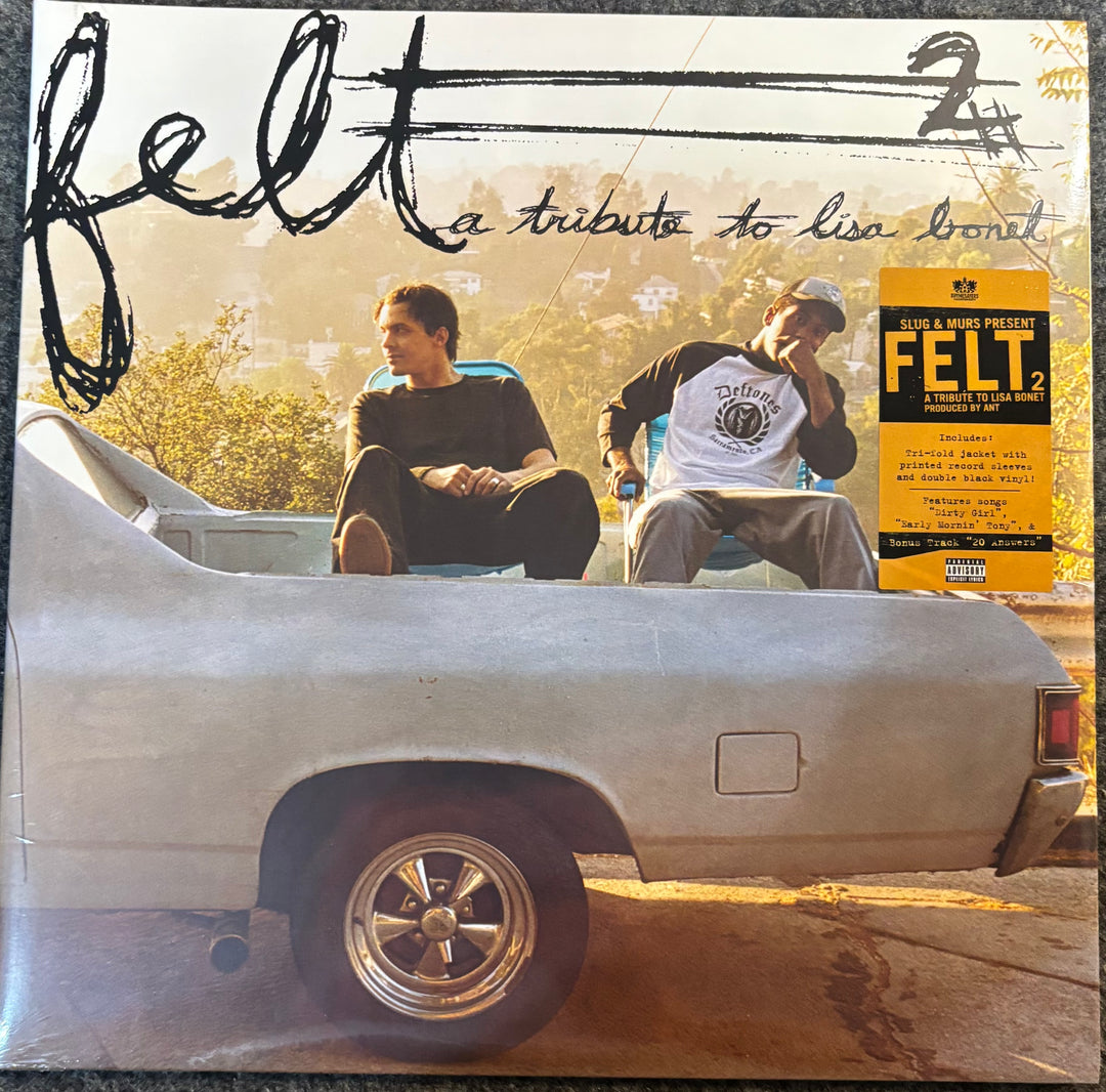 Felt - A Tribute to Lisa Bonet 12-inch vinyl LP album cover, featuring two men sitting in the bed of a silver car with a yellow sticker on the right side.