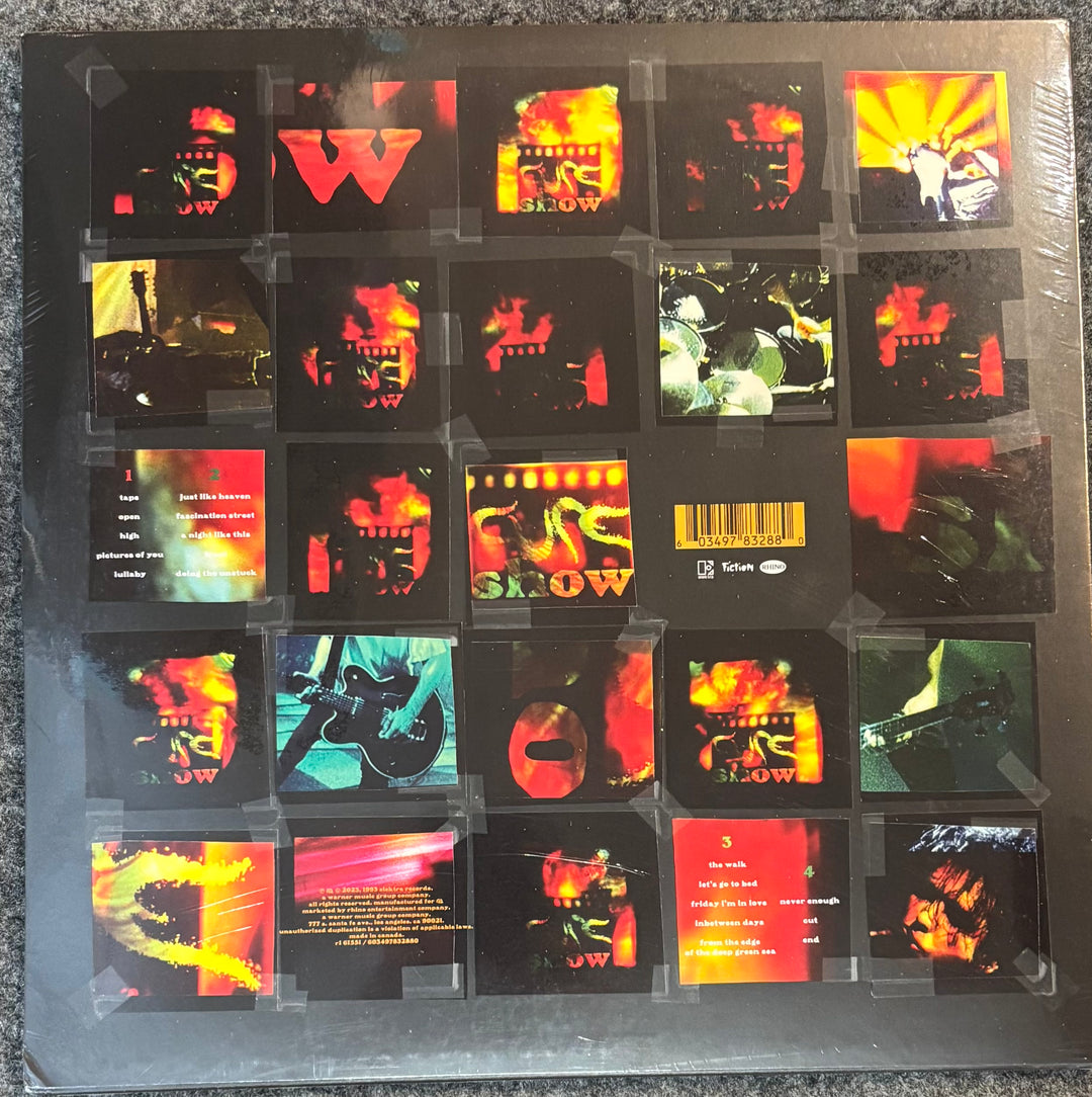 The Cure - Show with colorful covers arranged in a grid on a black background.