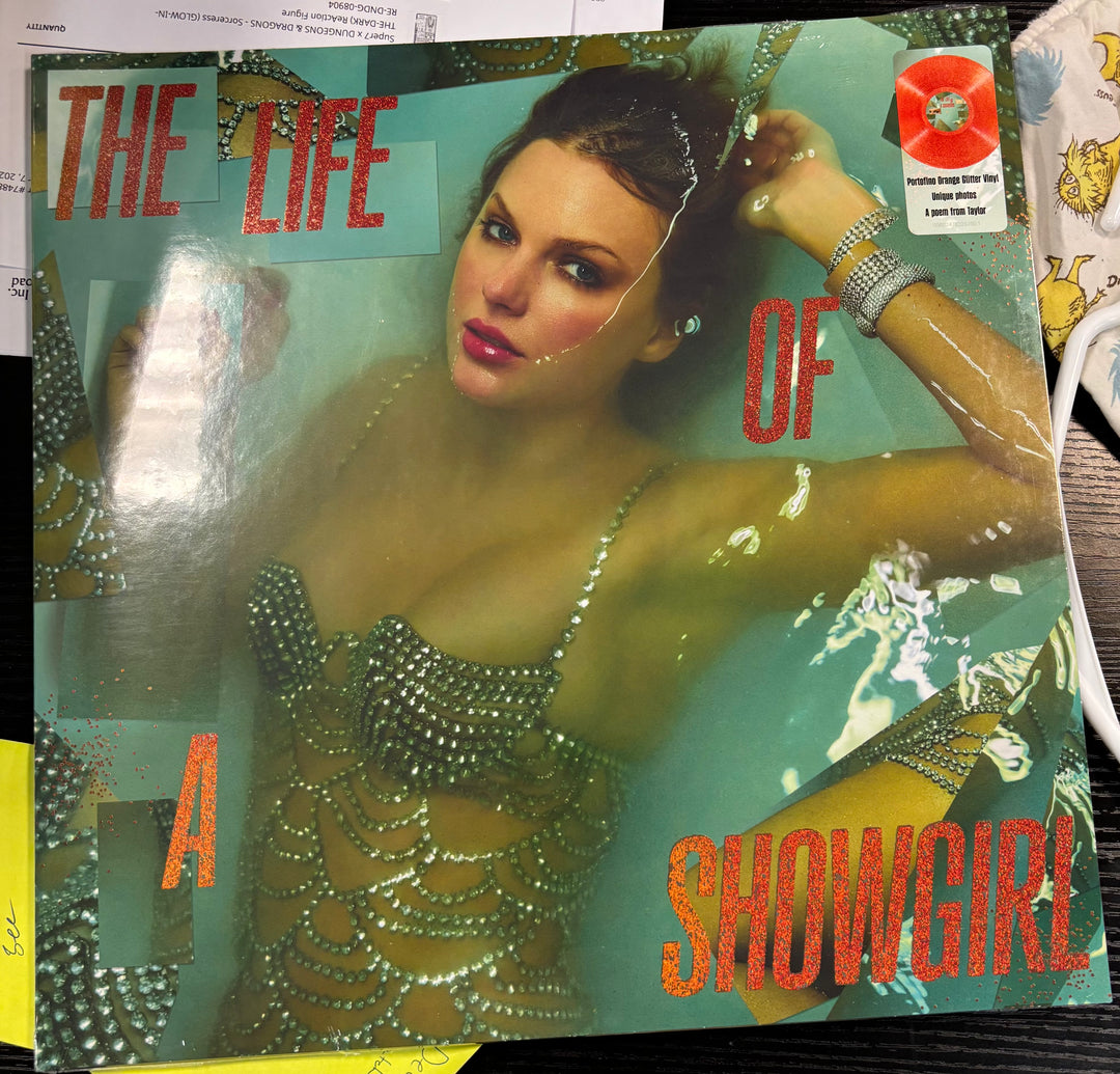 LP cover titled Taylor Swift 'The Life of a Showgirl' featuring a woman in a sparkling outfit.