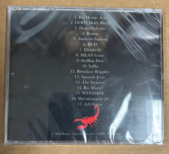 Back cover of a CD with tracklist and red scorpion logo on a reflective surface.