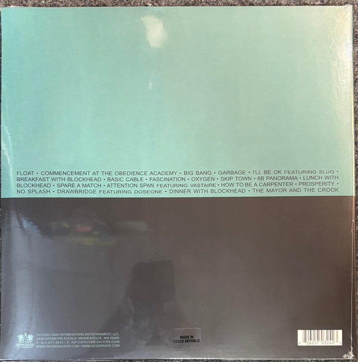 The back cover of Aesop Rock - Float, featuring a split design with a light mint green top section containing tracklist text and a dark charcoal bottom section with a barcode and small text.