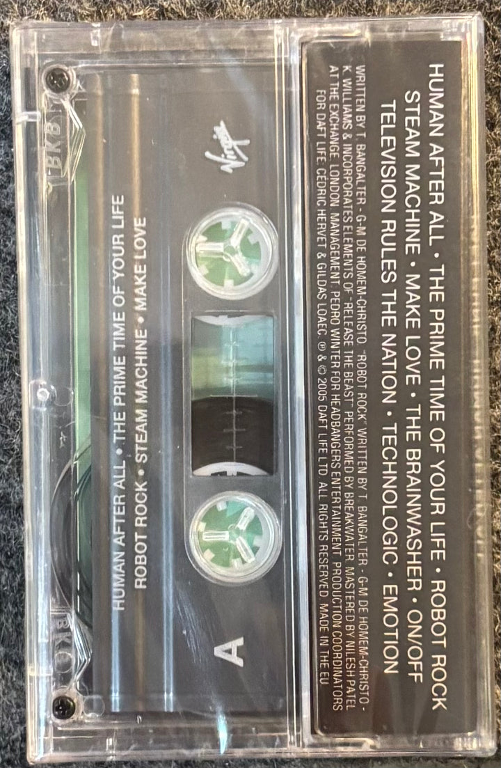 DAFT PUNK – HUMAN AFTER ALL tape with visible label and tape inside on a dark textured background