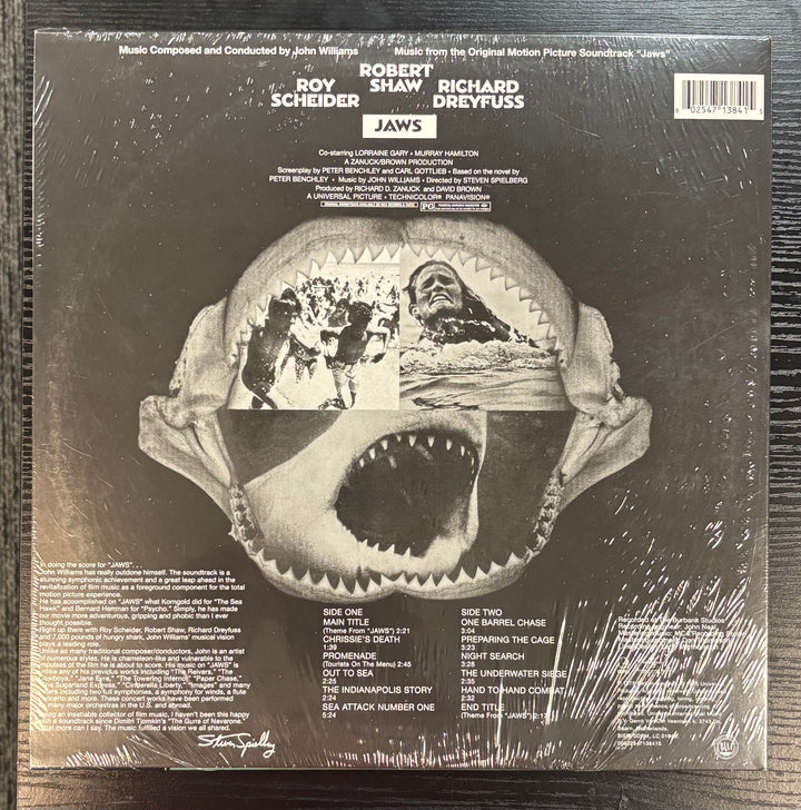 Back cover of a vinyl record with 'Jaws' movie poster design, featuring a shark and a person.