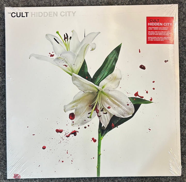 Album cover for 'Hidden City' by The Cult featuring white lilies and red specks.