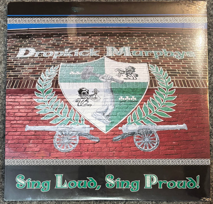Vinyl album cover with 'Dropkick Murphys' logo and text on a brick wall background