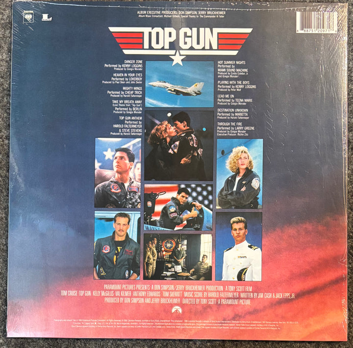The back cover of the Top Gun soundtrack vinyl record, sealed in its plastic shrink wrap, showing the film's cast and production credits on a dark blue and red gradient background.