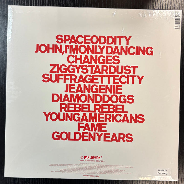 Album cover with red text on a beige background