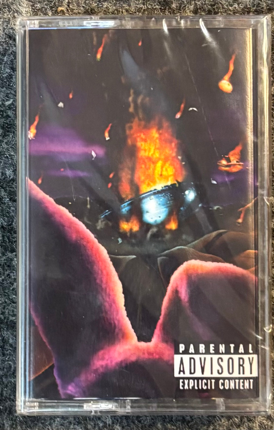 GIBBS, FREDDIE - $OUL $OLD $EPARATELY tape with a fiery design and 'Parental Advisory Explicit Content' label on a textured surface.