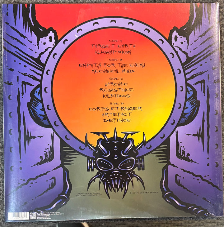 VOIVOD - Target Earth record cover with a stylized alien face and text on a red and purple background