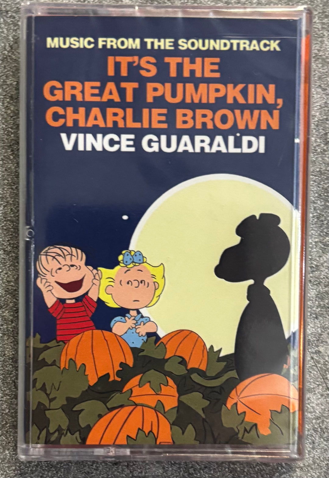 Cassette tape cover of 'It's the Great Pumpkin, Charlie Brown' soundtrack with cartoon characters and pumpkins.