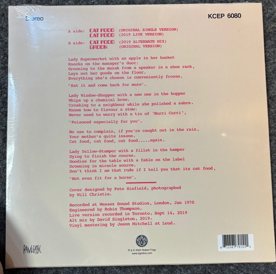 Back cover of  King Crimson's 'Cat Food/Groon with text and a barcode on a gray surface
