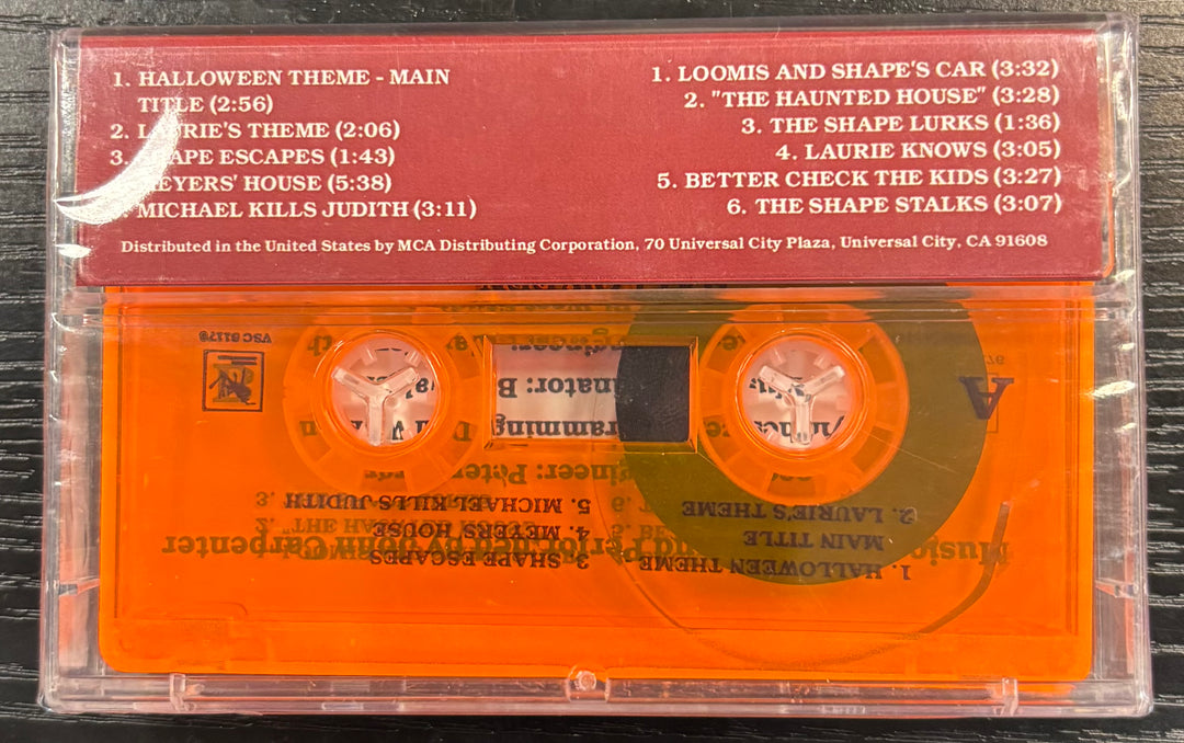 HALLOWEEN Orange cassette tape with a Halloween-themed label on a black background