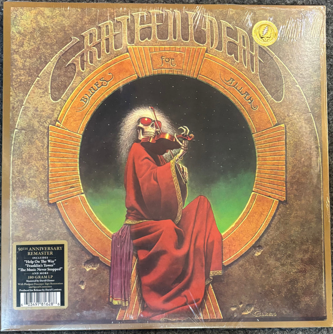 Grateful Dead - Blues For Allah cover with a figure in red robes and helmet, surrounded by decorative text and symbols.
