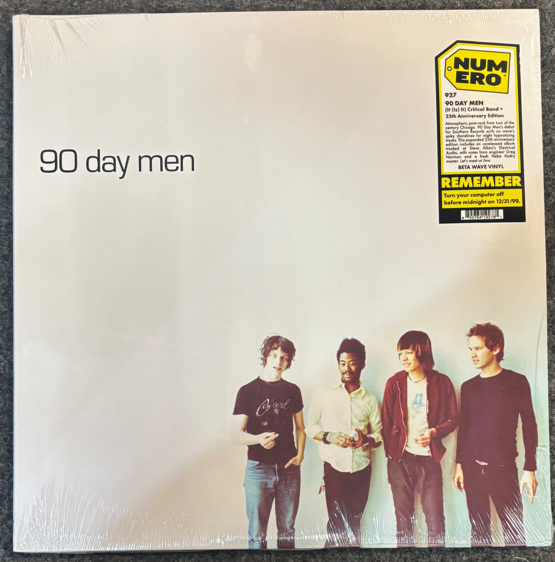 The front cover of 90 Day Men - (It (Is) It) Critical Band + (Y2K 25th Anniversary Edition), sealed in plastic shrink wrap. The cover is off-white with the band members' photo at the bottom and a yellow/black Numero sticker in the top right corner.