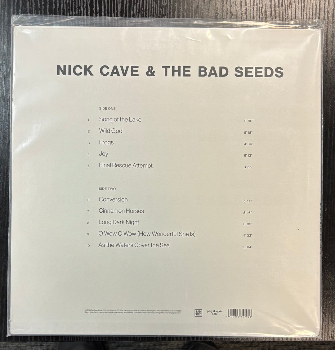 Back cover of NICK CAVE & THE BAD SEEDS - WILD GOD with tracklist on a wooden surface