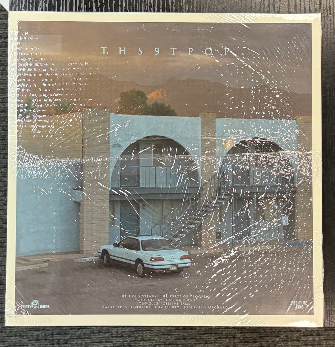 Hold Steady, The – The Price Of Progress cover with a car parked in front of a building, featuring the text 'T.H.S9TOP'.
