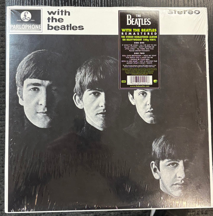 Beatles, The - With The Beatles record cover with a black and white photo of four individuals and text on a white background.