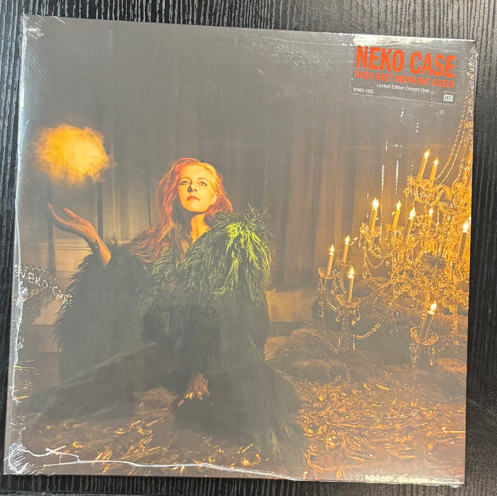 CASE, NEKO - NEON GREY MIDNIGHT GREEN record cover featuring a person in a dark room with candles and a chandelier, titled 'Neko Case'.