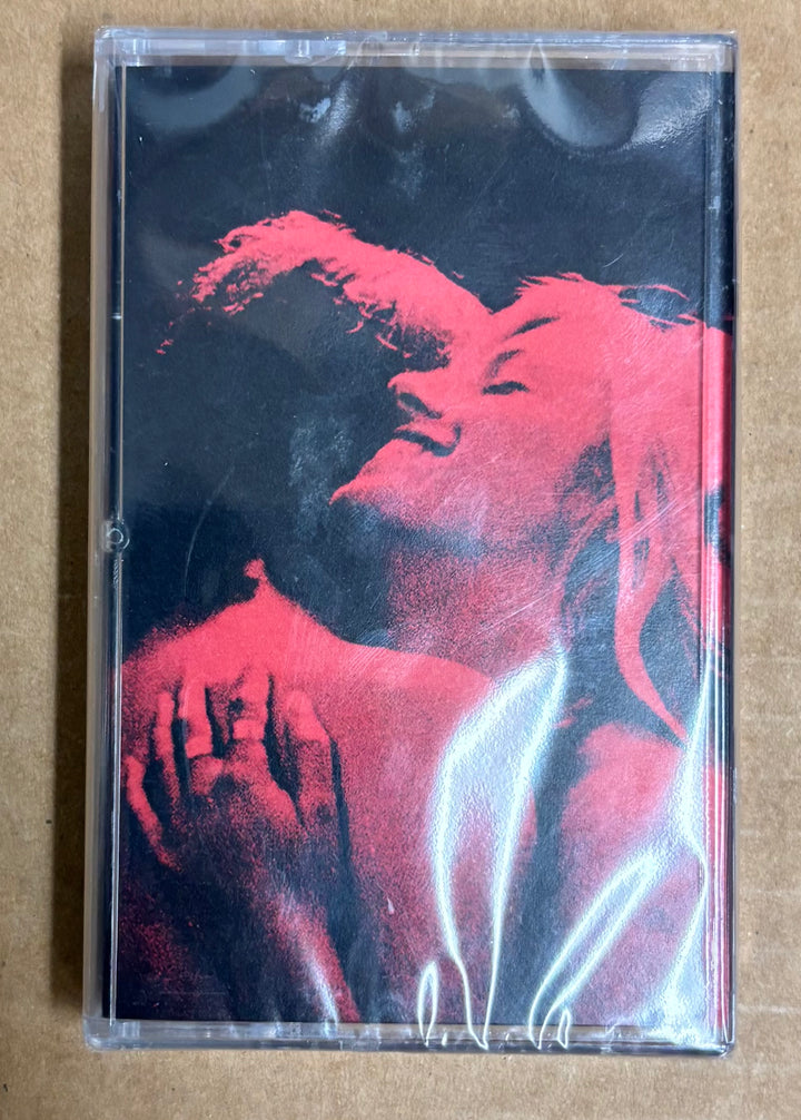 Cassette tape with a red and black graphic design on a beige background