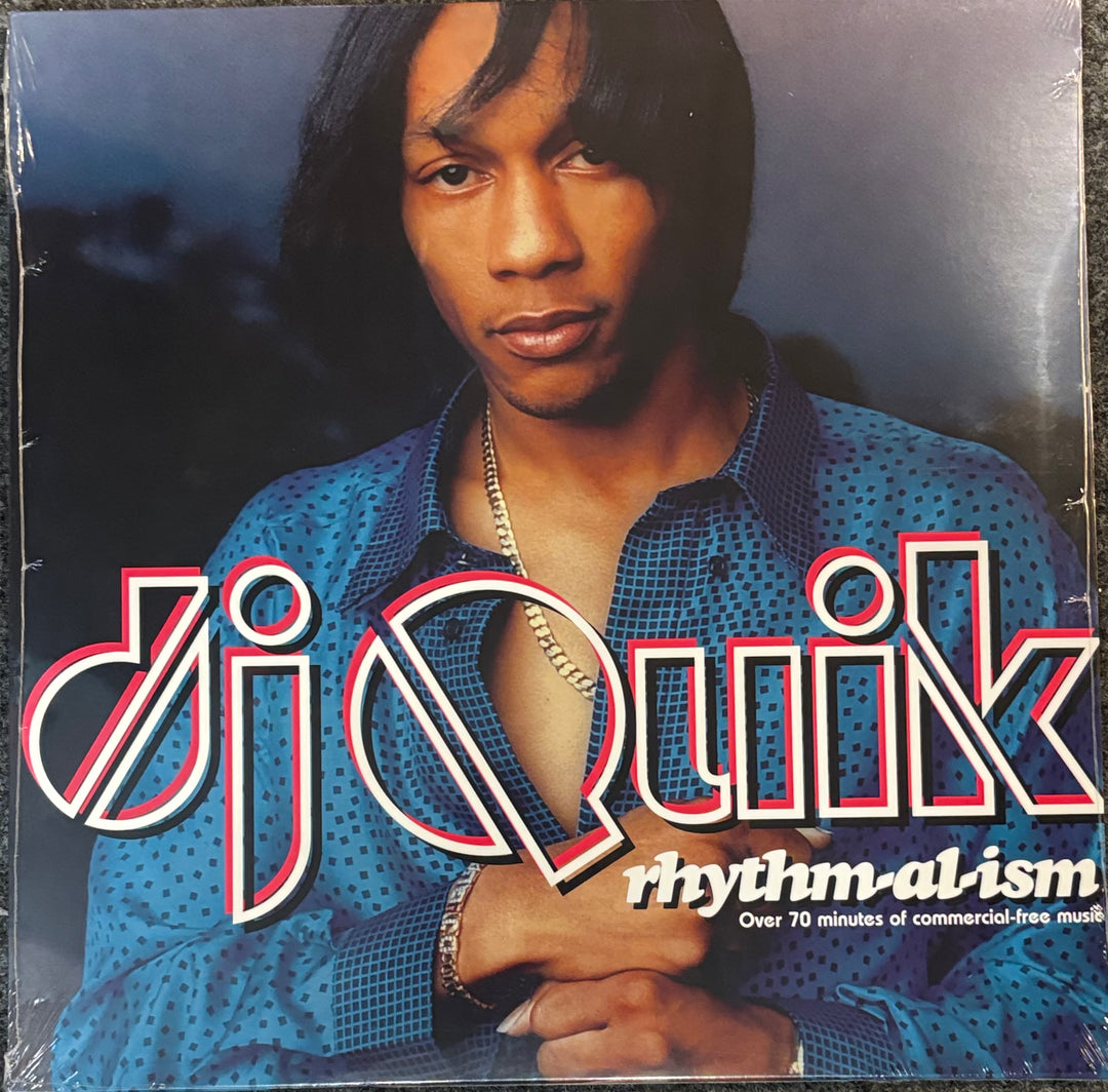 DJ Quik – Rhythm-al-ism Album cover with a person wearing a blue patterned shirt and 'dj Quik' text.