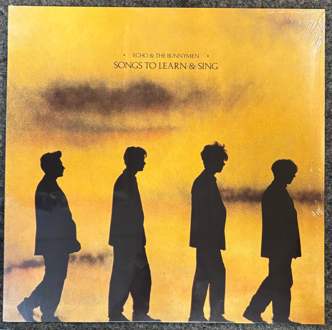ECHO & THE BUNNYMEN – Songs To Learn & Sing cover with silhouettes of four people against a yellow sky, featuring the text 'Echo & The Bunnymen Songs to Learn & Sing'.