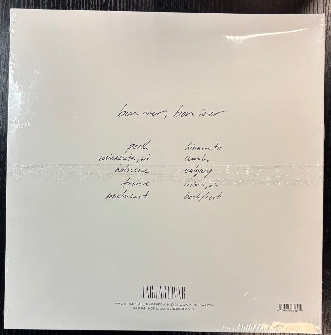 'Bon Iver' vinyl record packaging with text on a beige background