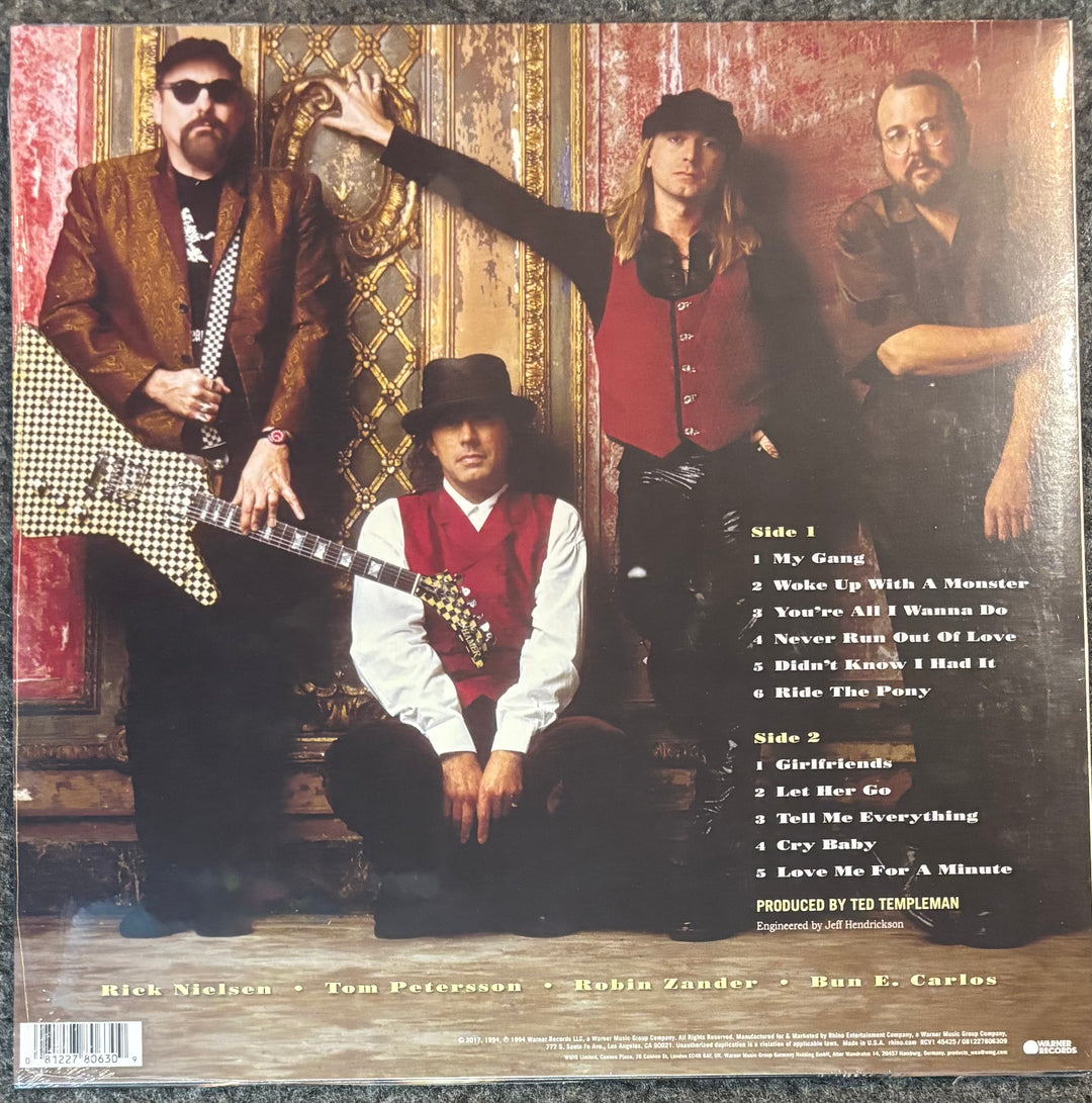 The back cover of Cheap Trick - Woke Up With A Monsterl, featuring a group photo of four country music artists against an ornate gold and red background. The right side displays the tracklist, and the bottom shows the artist names and a barcode.