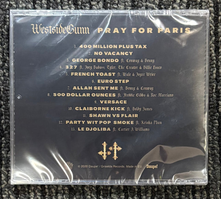 CD case with tracklist of Westside Gunn's 'Pray For Paris' album on a textured surface.