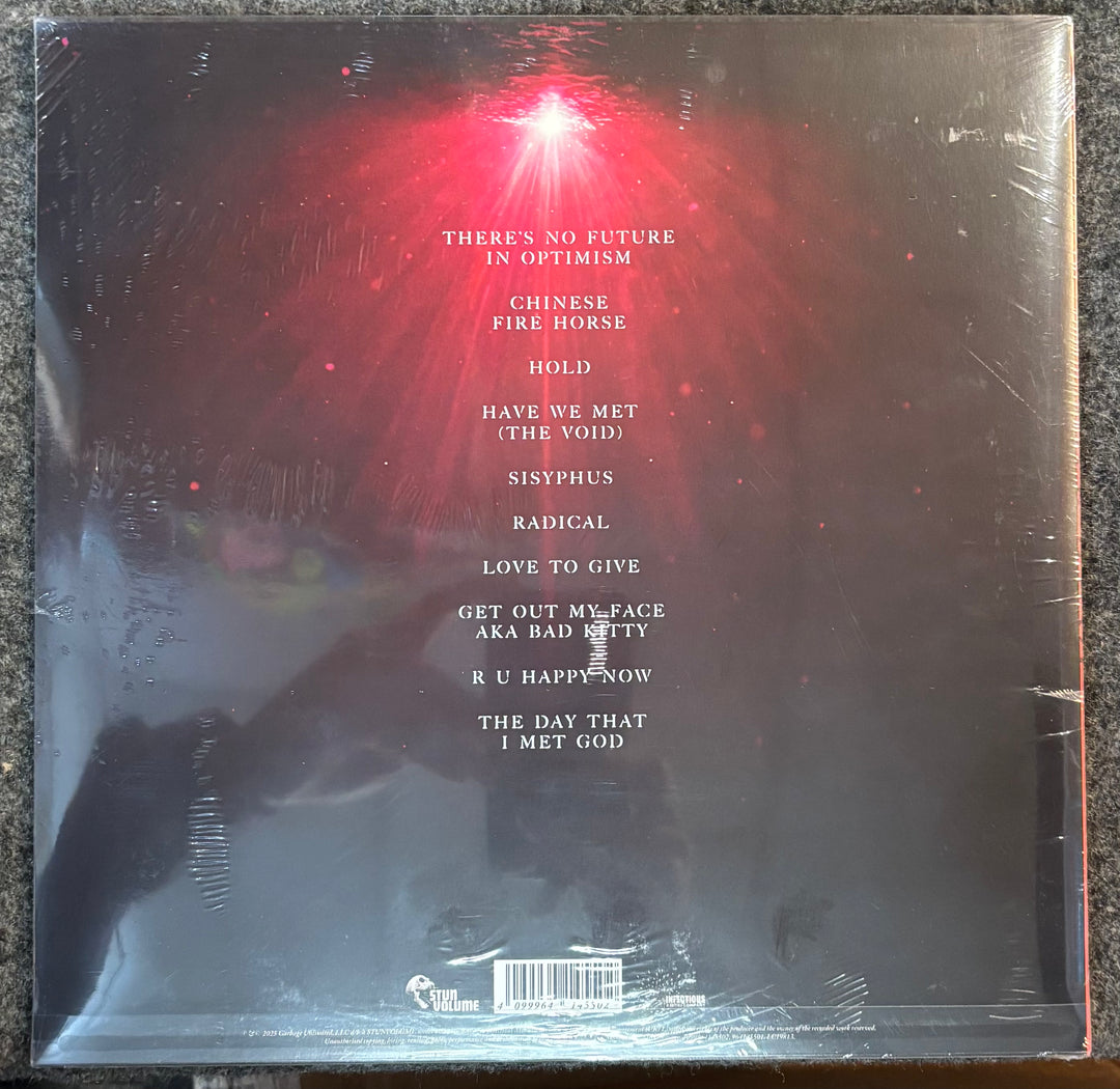 Back cover of GARBAGE - Let All That We Imagine Be The Light with text and a red light effect.