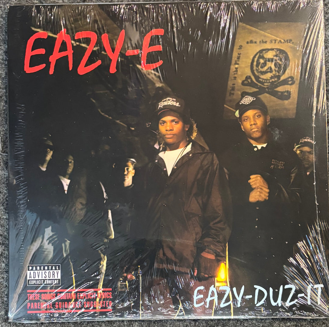 Album cover of 'Eazy-Duz-It' by Eazy-E with a group of people and text.