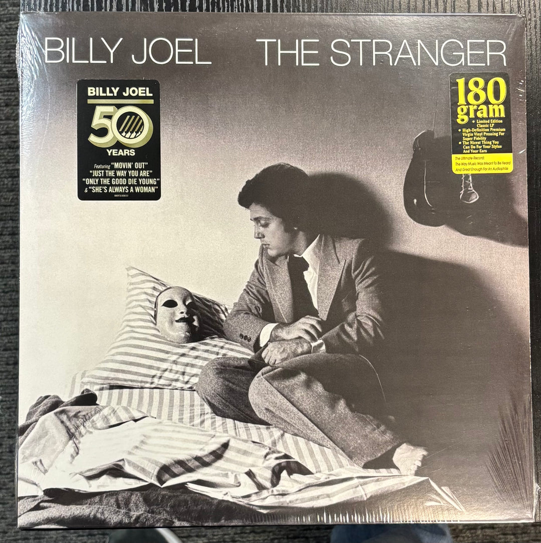 Vinyl album cover for 'The Stranger' by Billy Joel with a black and white image of a man and woman.