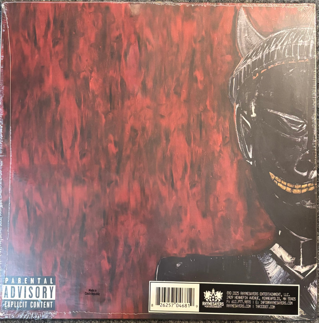 Vinyl record album cover for IDK – Even The Devil Smiles, showing a textured red background and a black hooded figure on the right, with a Parental Advisory label in the bottom left.