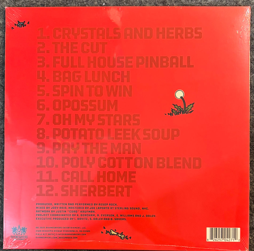 The back cover of a vinyl record for Aesop Rock - I Heard It’s A Mess There Too, featuring a bright red background with the 12 track titles printed in a matching terracotta red font.