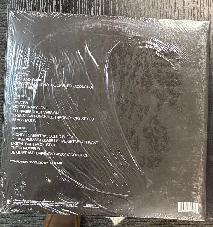 Back cover of a DEFTONES - B-Side & Rarities with text and a patterned design