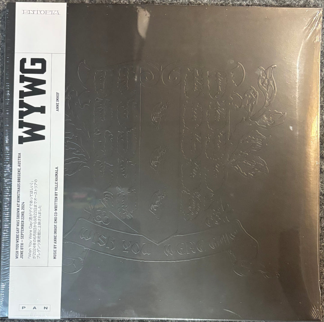 A square vinyl record sleeve for Anne Imhof - WYWG, featuring a metallic bronze embossed crest on a dark background with a white vertical label on the left.