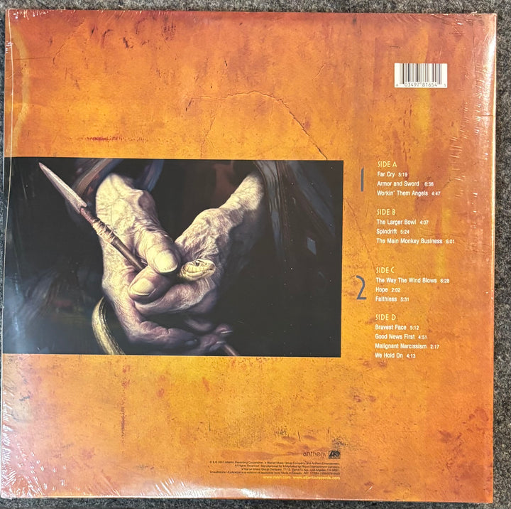 RUSH - SNAKES & ARROWS record sleeve with a hand holding a spear and album tracklist on an orange background