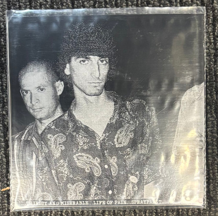 Black Flag Licorice Pizza back album cover with two people in patterned shirts on a textured surface
