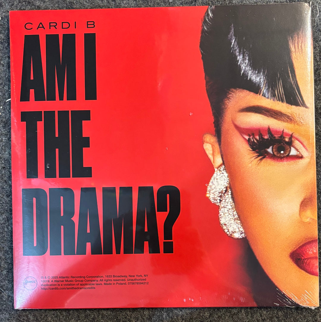 Album cover of 'Am I The Drama?' by Cardi B with a close-up of a woman's face on a red background.