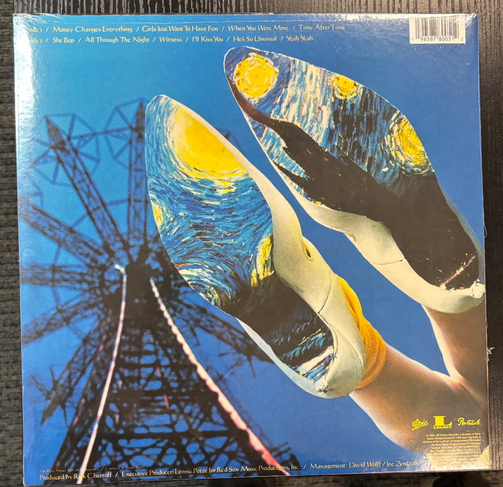 Cyndi Lauper - She's So Unusual record cover with artistic design of a Ferris wheel and hands holding a record
