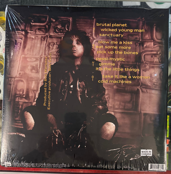 ALICE COOPER - Brutal Planet record cover with a person in a dark outfit and text on a spaceship interior background