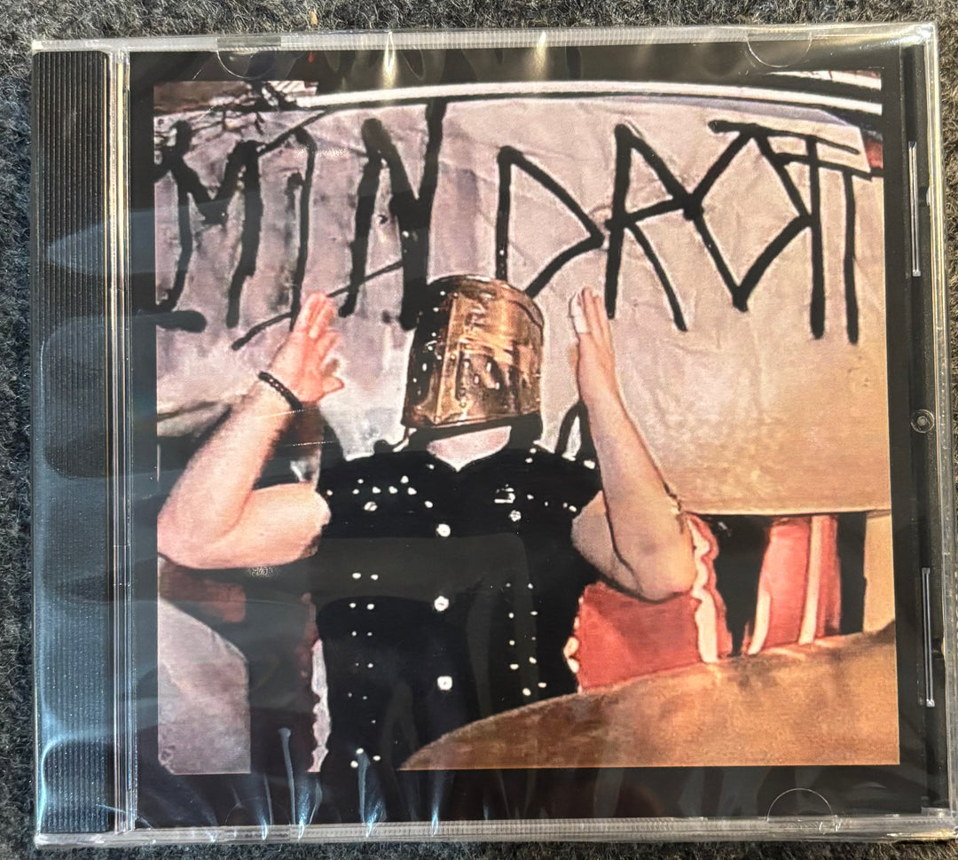Mindrott - Mindrott CD cover with a person wearing a helmet and another person in the background, with text on the wall.