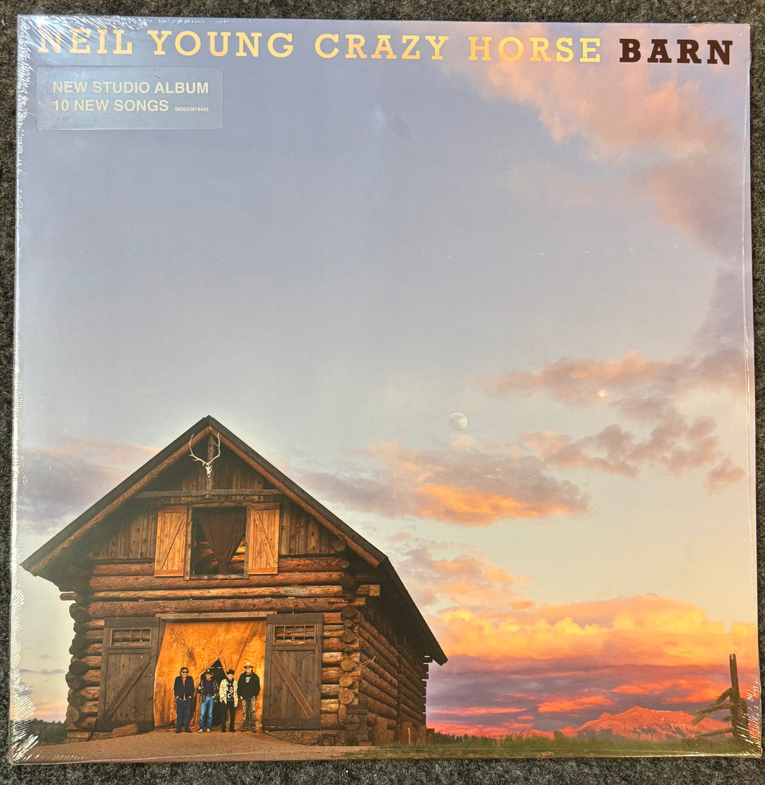 Album cover of 'Barn' by Neil Young Crazy Horse with a log cabin and sunset.