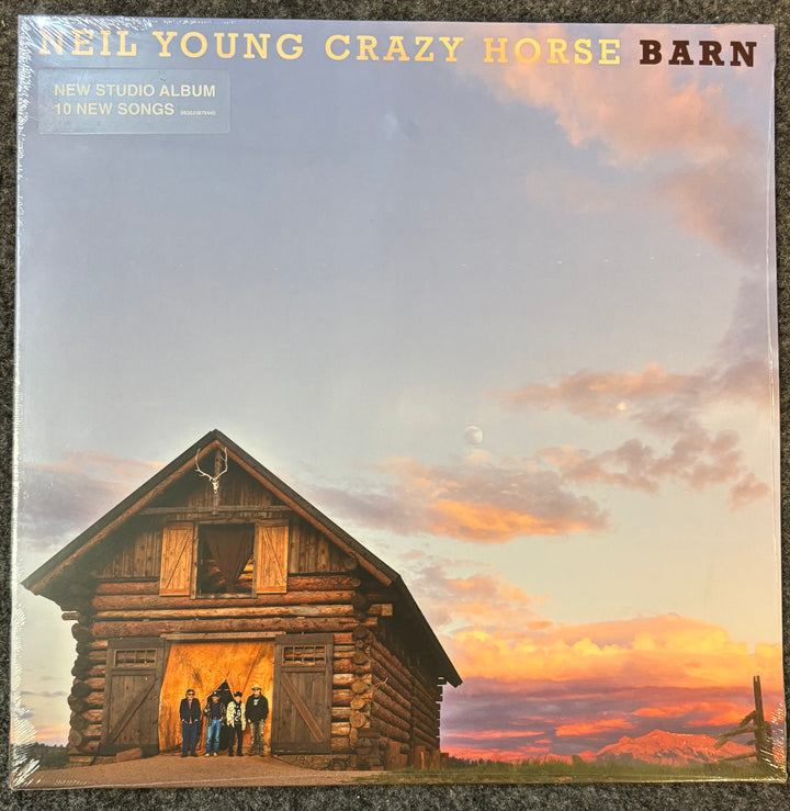 Album cover of 'Barn' by Neil Young Crazy Horse with a log cabin and sunset.