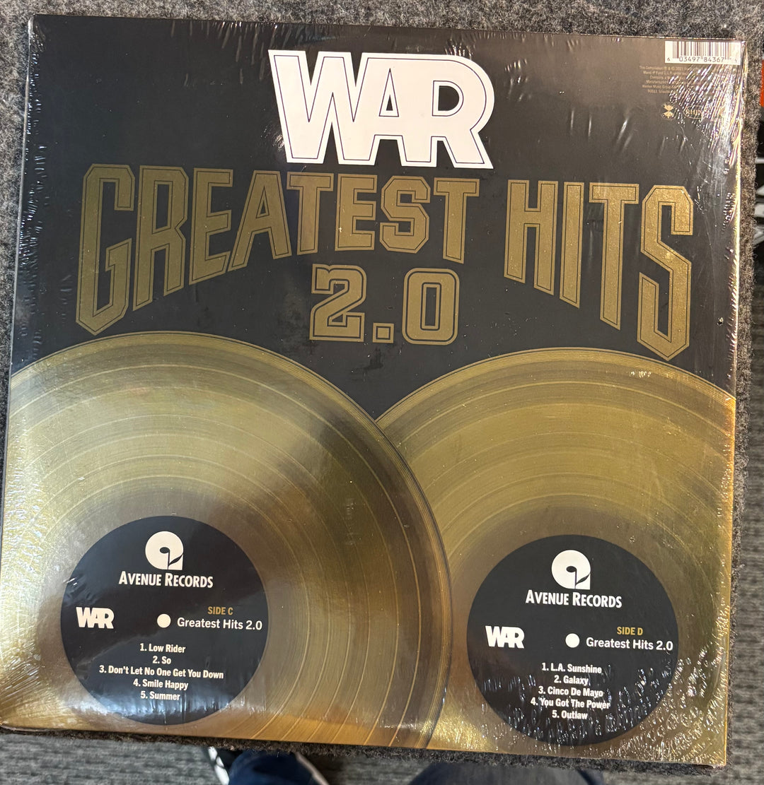 WAR - Greatest Hits 2.0 record set with 'WAR Greatest Hits 2.0' cover on a textured surface