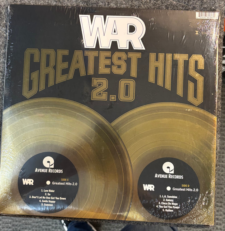 WAR - Greatest Hits 2.0 record set with 'WAR Greatest Hits 2.0' cover on a textured surface