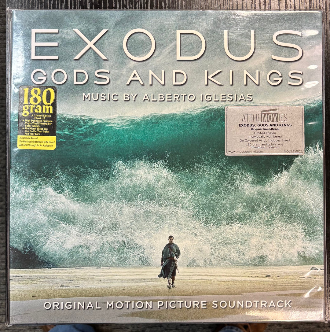 Vinyl album cover for 'Exodus: Gods and Kings' soundtrack with ocean and person walking scene.