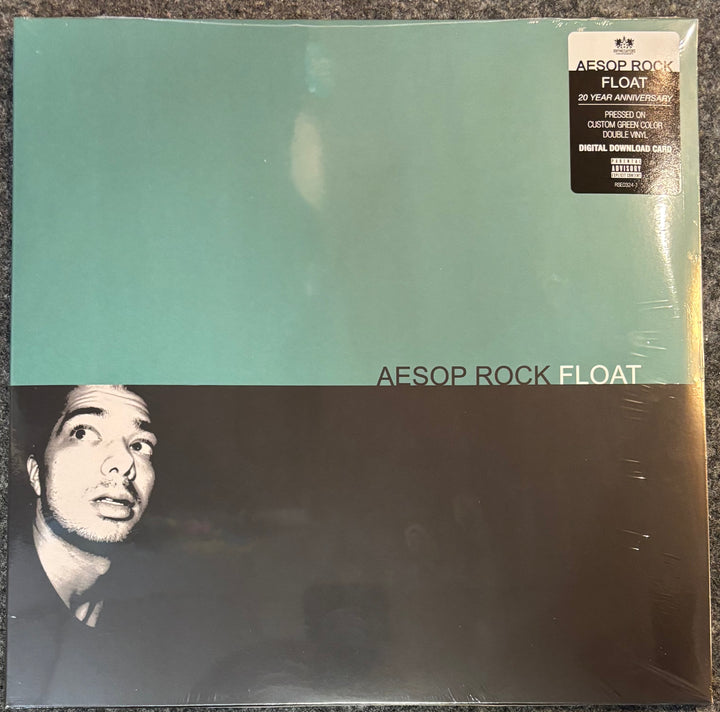 A vinyl record sleeve for Aesop Rock - Float 20 Year Anniversary edition, sealed in plastic. The cover features a split design with a light teal top half and a black-and-white portrait of the artist on the bottom half.
