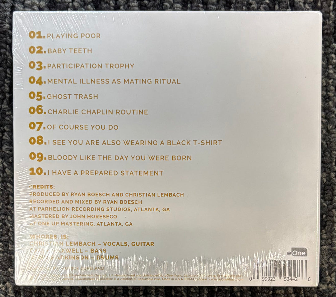 Back cover of a Whores. album with tracklist and production credits on a textured surface
