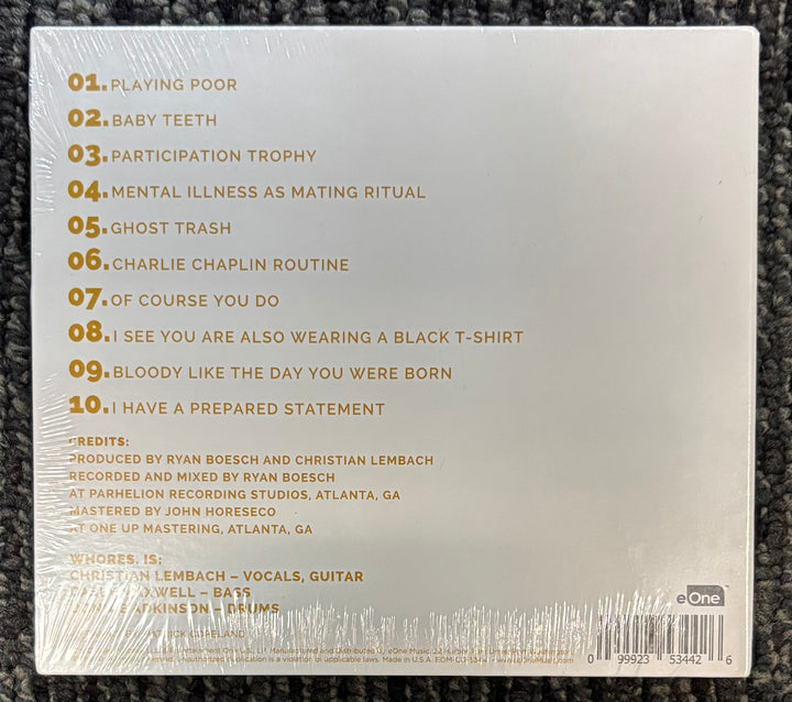 Back cover of a Whores. album with tracklist and production credits on a textured surface