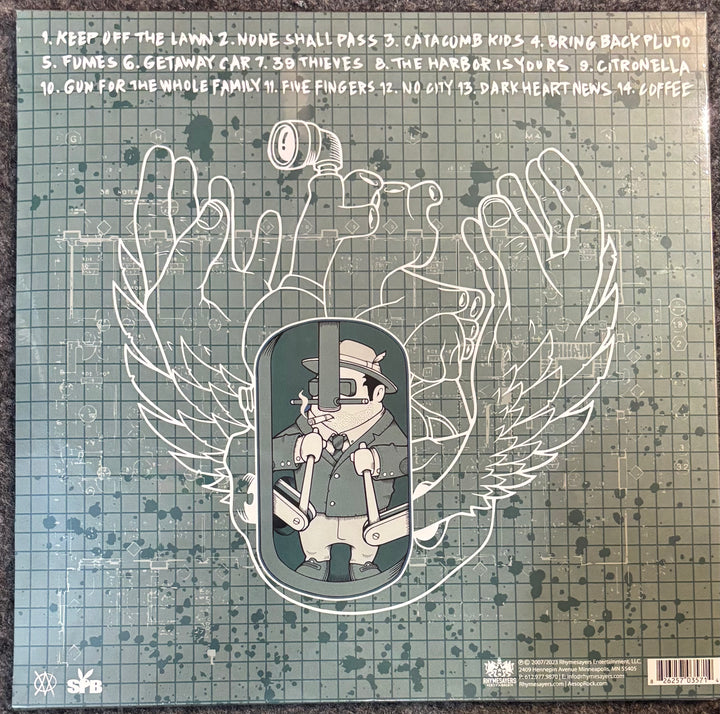 Vinyl record sleeve for Aesop Rock - None Shall Pass, featuring a stylized illustration of a man in a hat and coat inside a hanging machine, surrounded by large outlined wings, on a green gridded background with tracklist text at the top.
